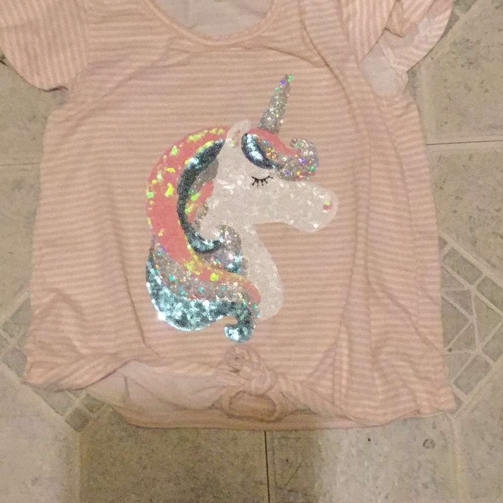 A unicorn shirt idk the brand